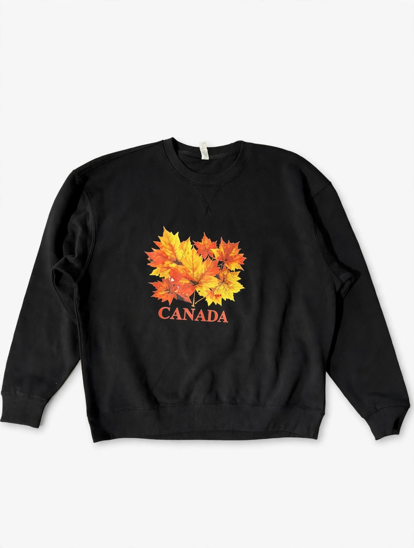 Black sweatshirt with a bold Canada maple leaf print, printed by Ink Experts
